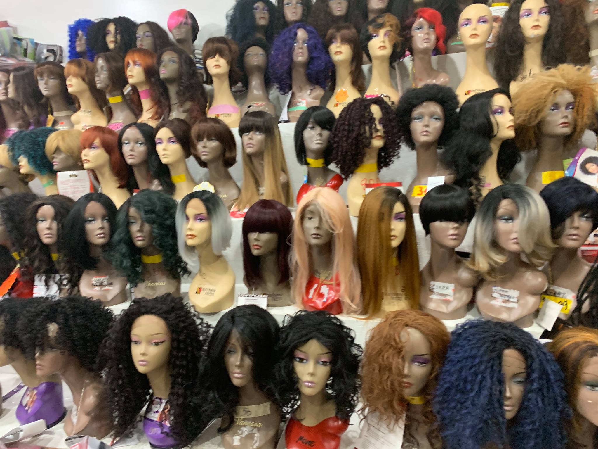 Wig mannequins displayed in natural tones at Mimi Beauty Supply