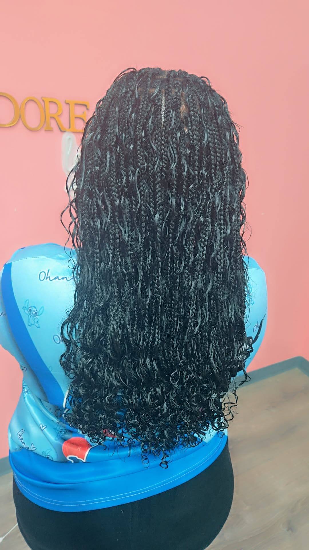 Black passion twists with curly ends on pink background