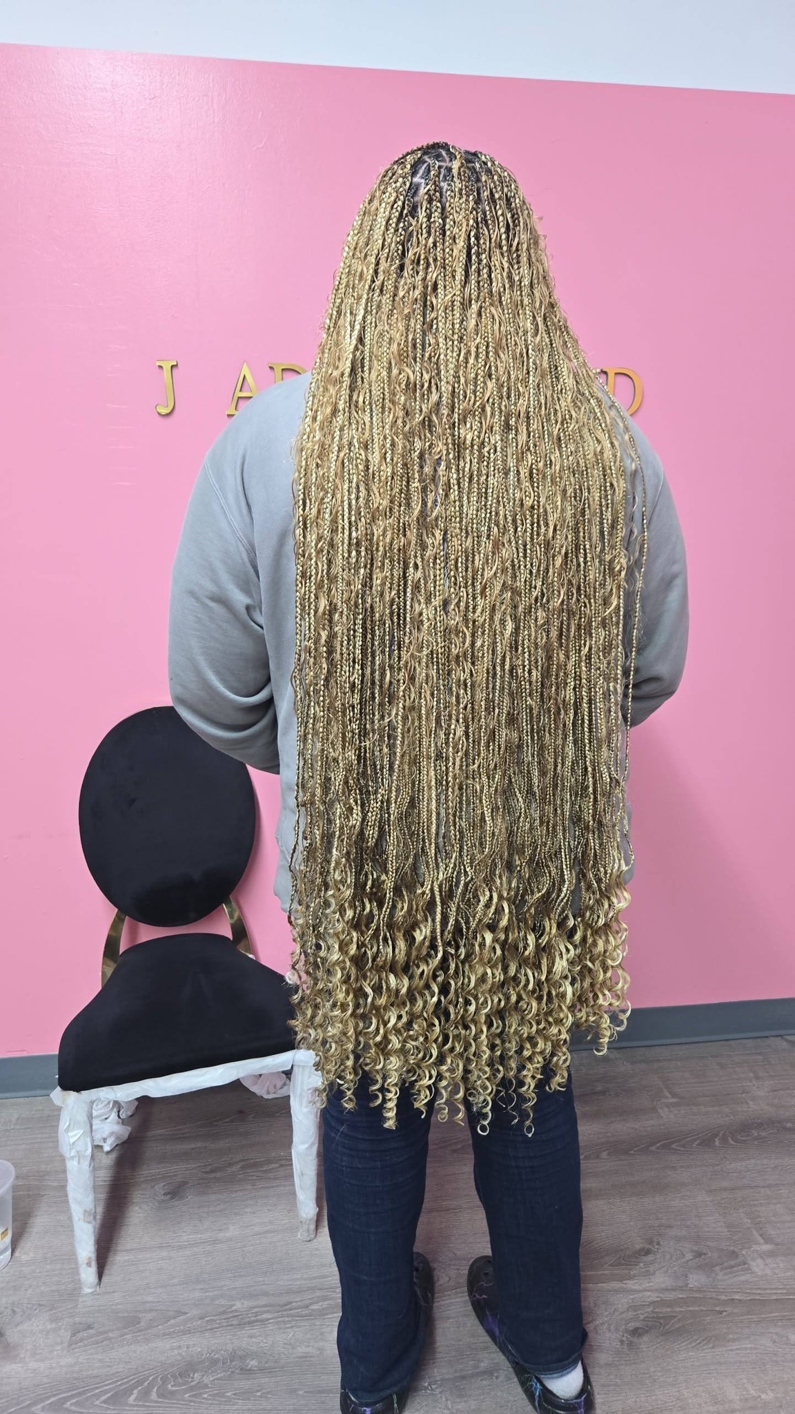 Long gold blonde goddess locs on pink background