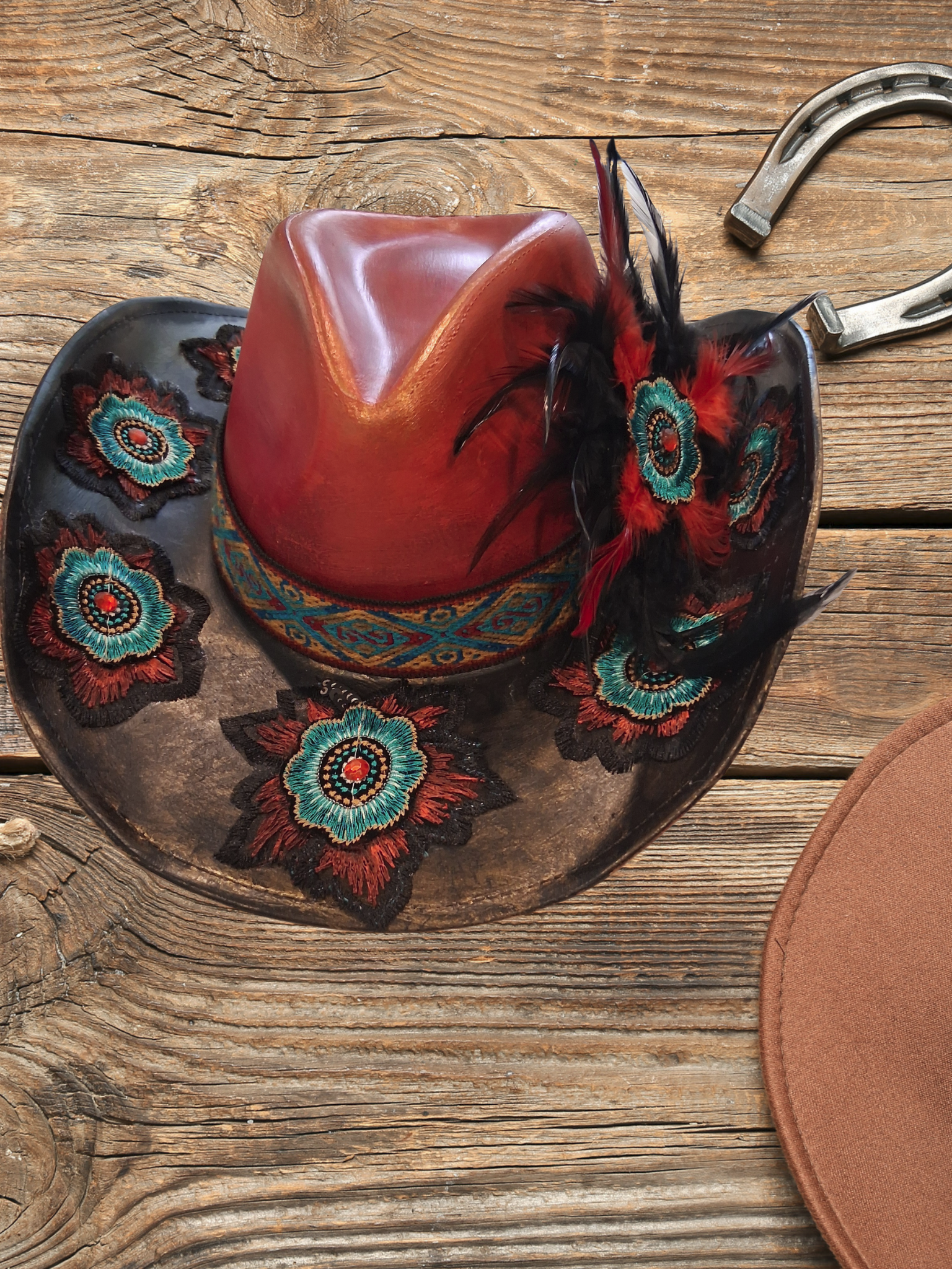 Custom hat with a beaded band and feather, by Hunee Hats