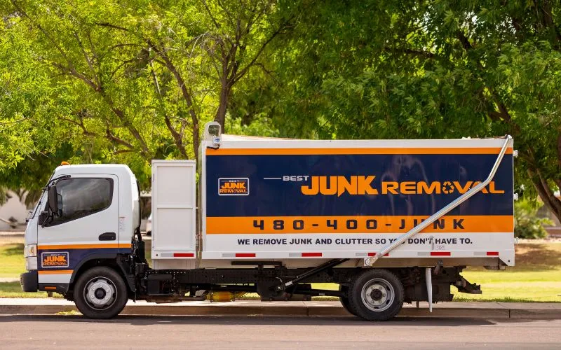 Brandon Hancock, owner of Best Junk Removal, standing with the team truck and trailer