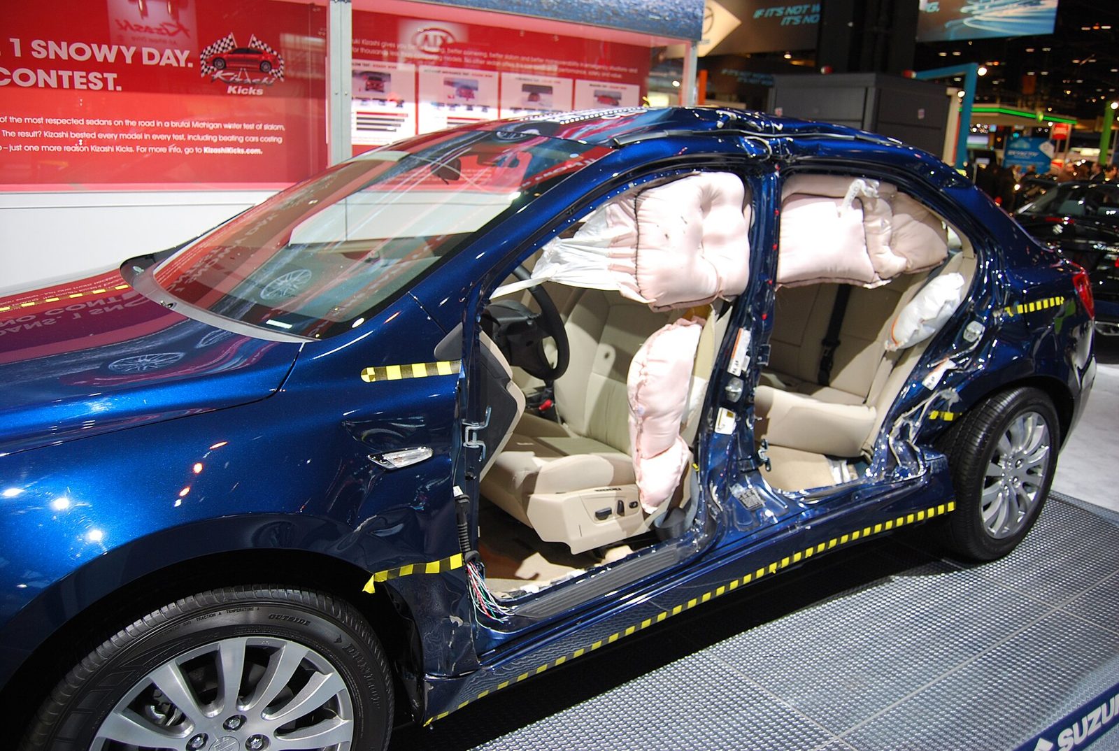 Deployed side-curtain and front airbags shown on a display vehicle