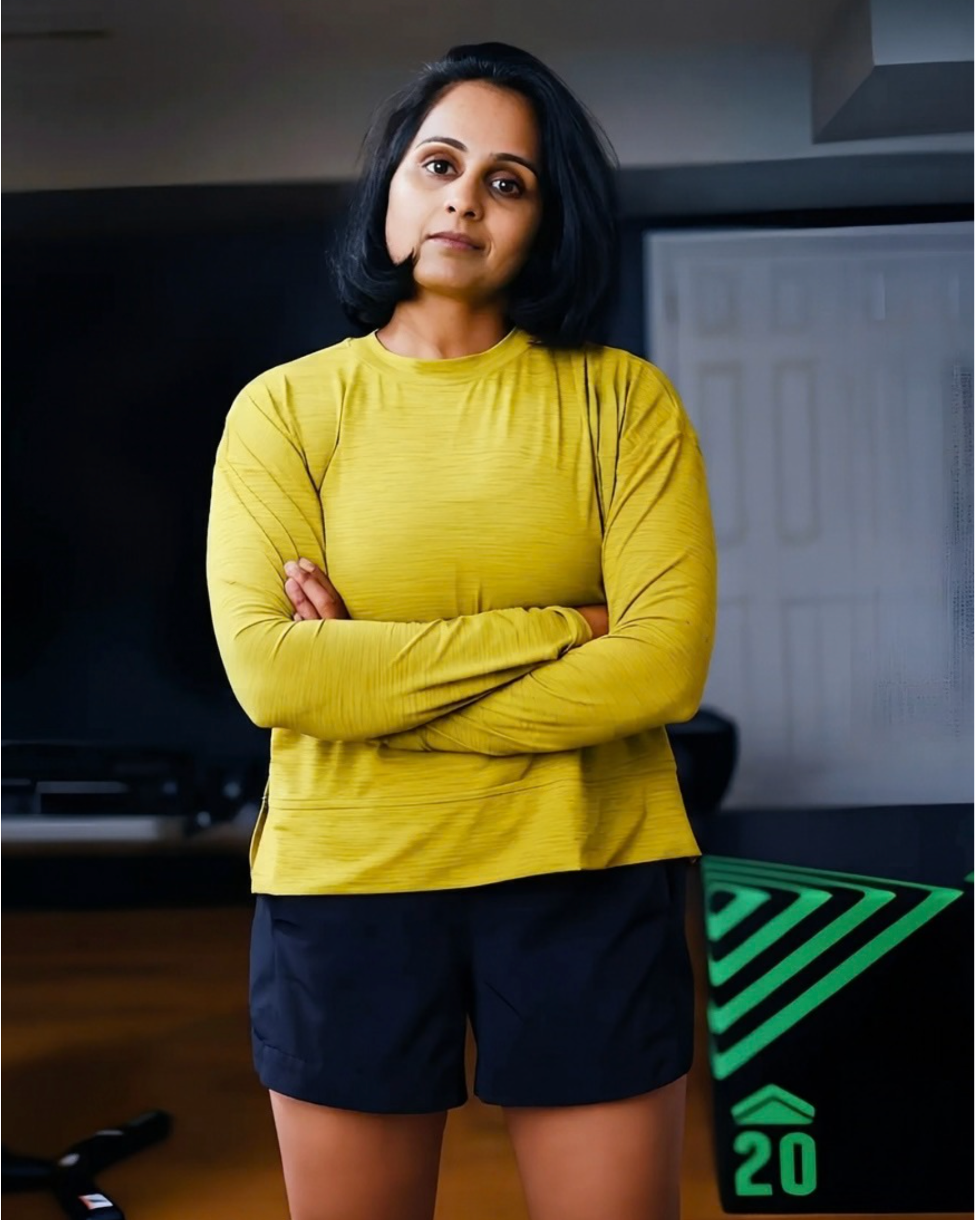 Geeta standing confidently in her training space