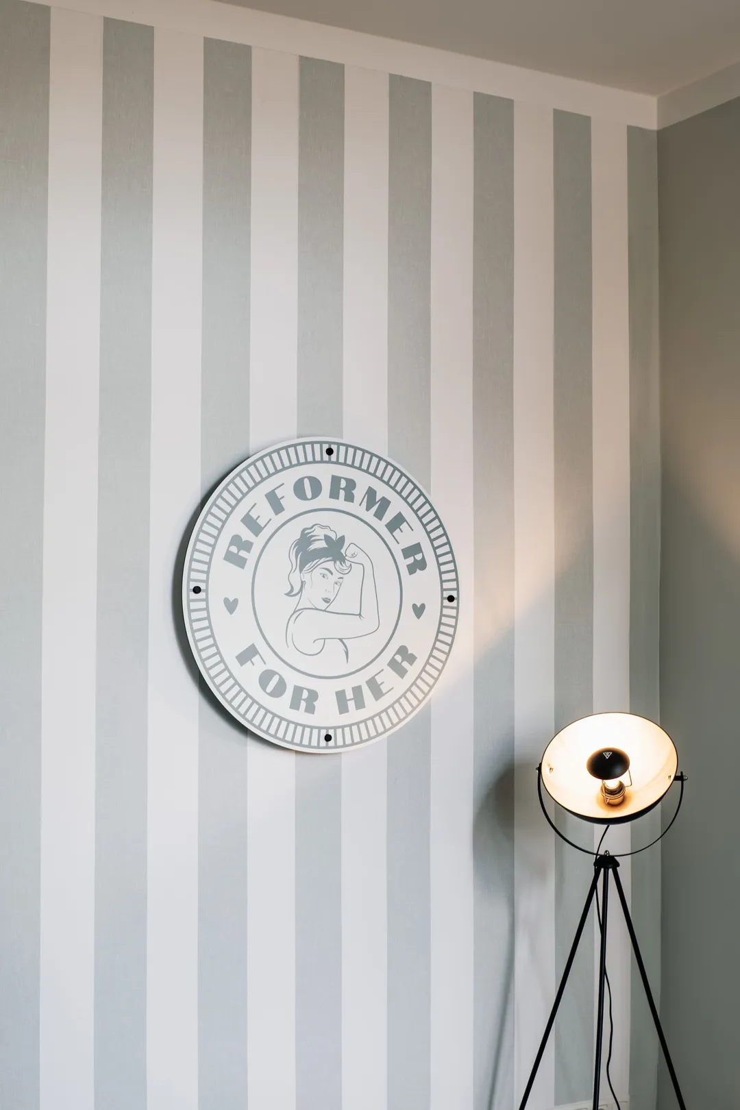 The Reformer For Her logo on the studio wall