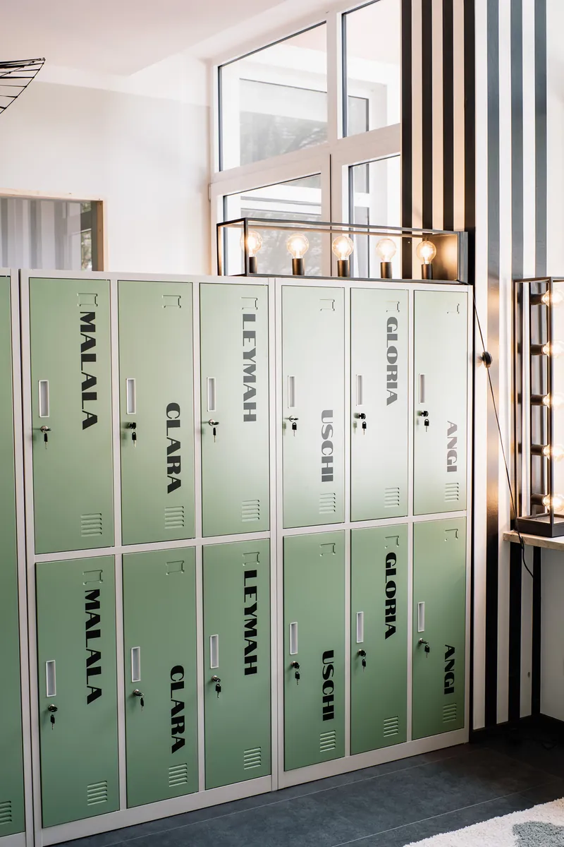 Green lockers named after inspiring women, like Malala, Clara and Gloria
