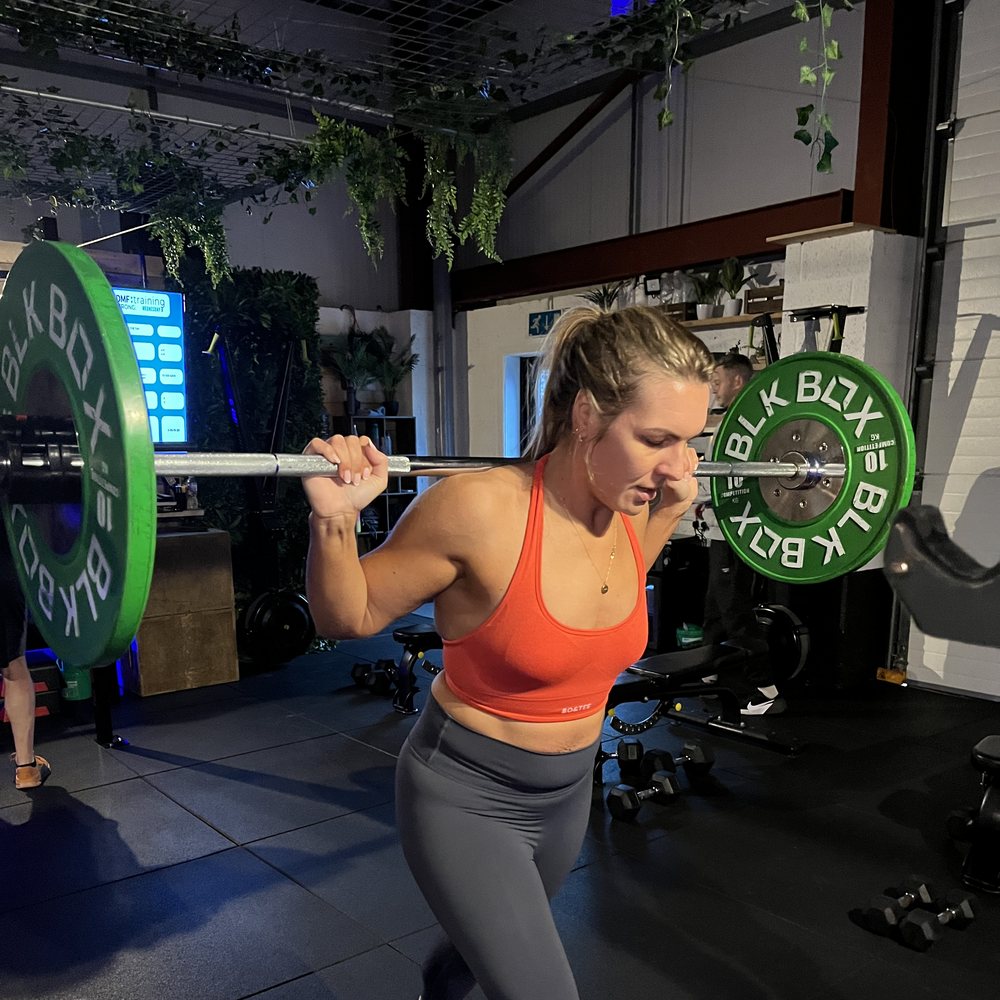 Member front squatting at DMF Evolve