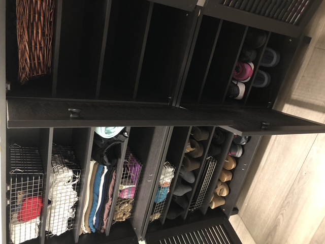Organized shoe and clothing storage with footwear arranged in accessible rows