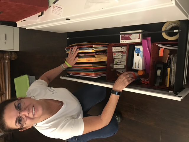 A home office filing system with documents organized into labeled folders