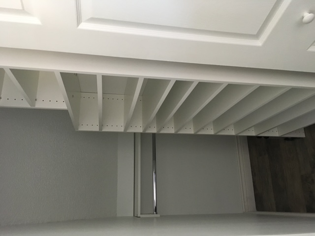 Custom closet shelving built to use the full height of the space