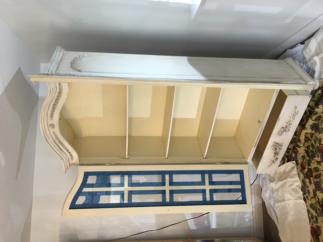 A decorative cabinet part way through restoration