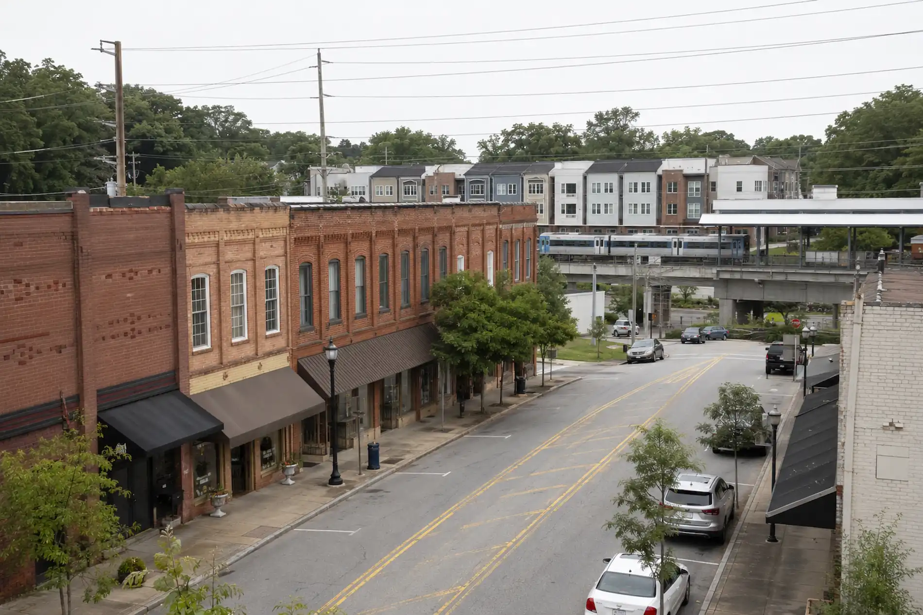 Downtown East Point storefronts with the MARTA line and new townhome infill behind