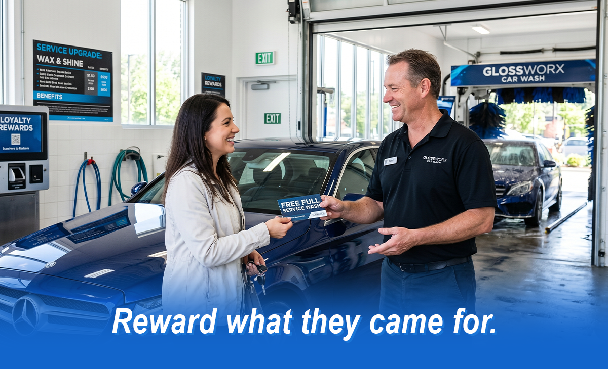 Car wash employee giving customer a free full-service wash voucher beside vehicle in wash bay, highlighting customer rewards, loyalty programs, and satisfaction at a professional car wash.