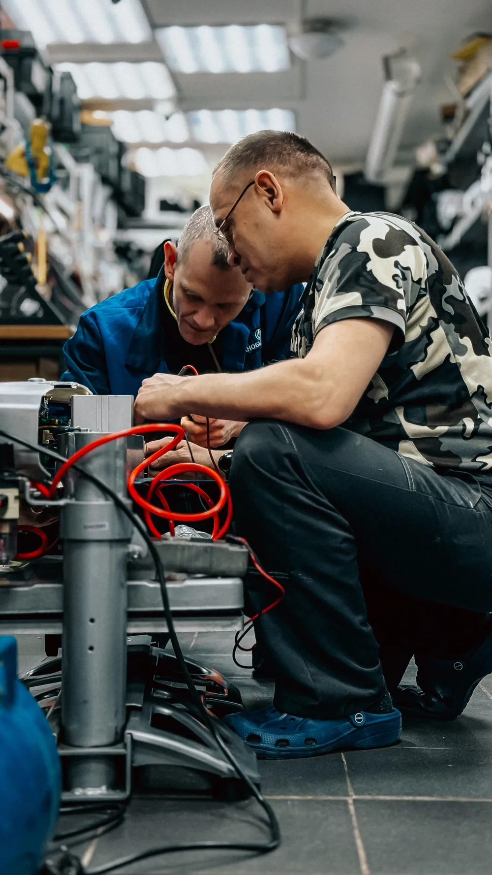 Technician using refrigeration gauges and a multimeter on a sealed system, the skills covered by EPA 608 certification