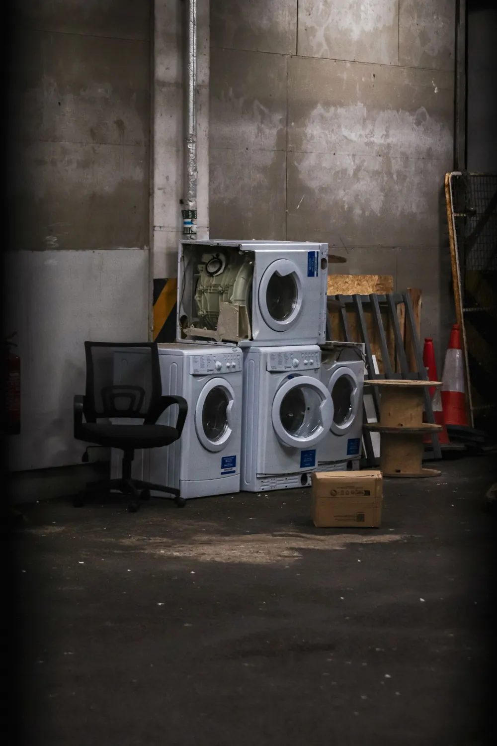Washing machines stacked and waiting for repair, showing steady demand for appliance repair technicians