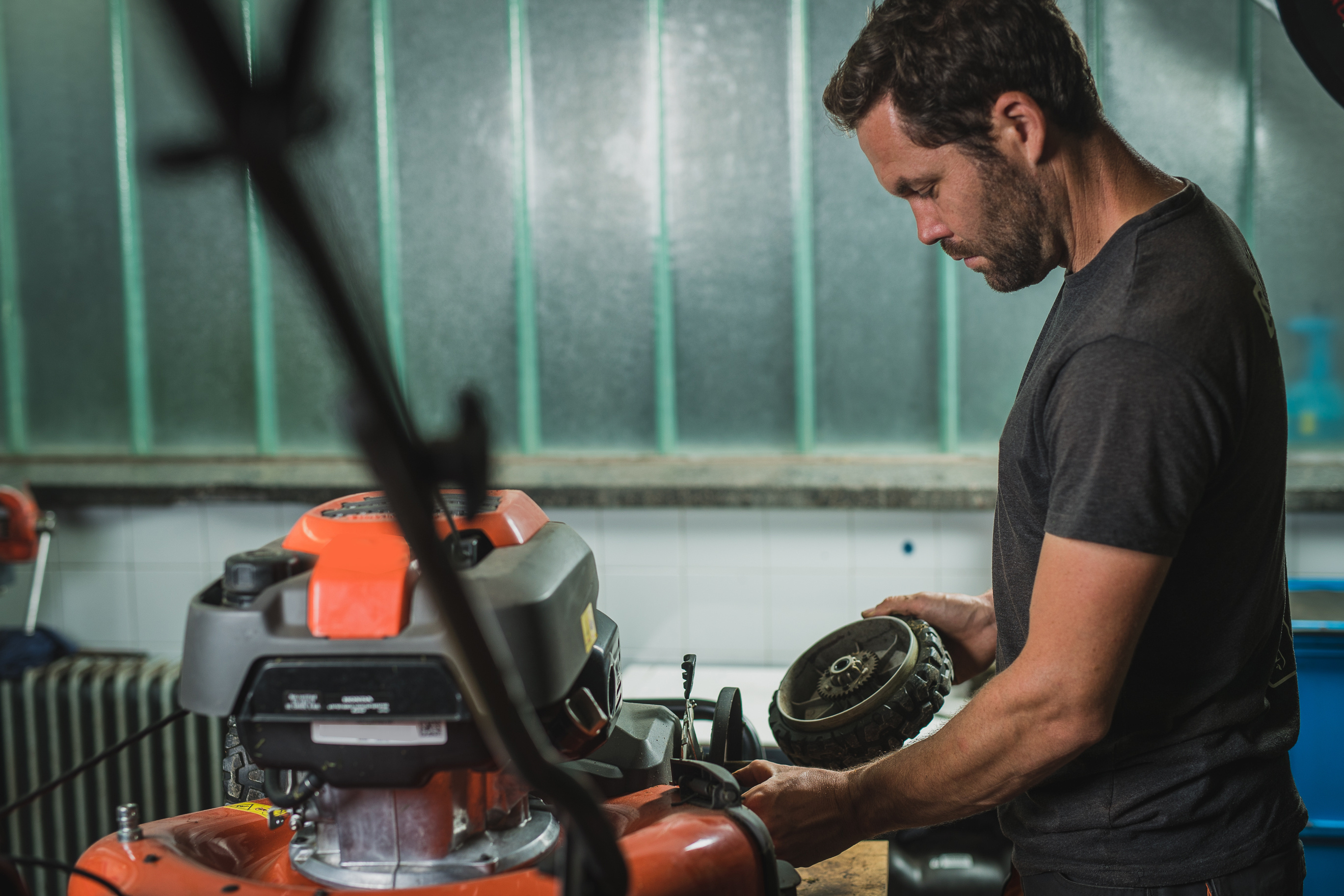 Technician working on mower and snowblower equipment