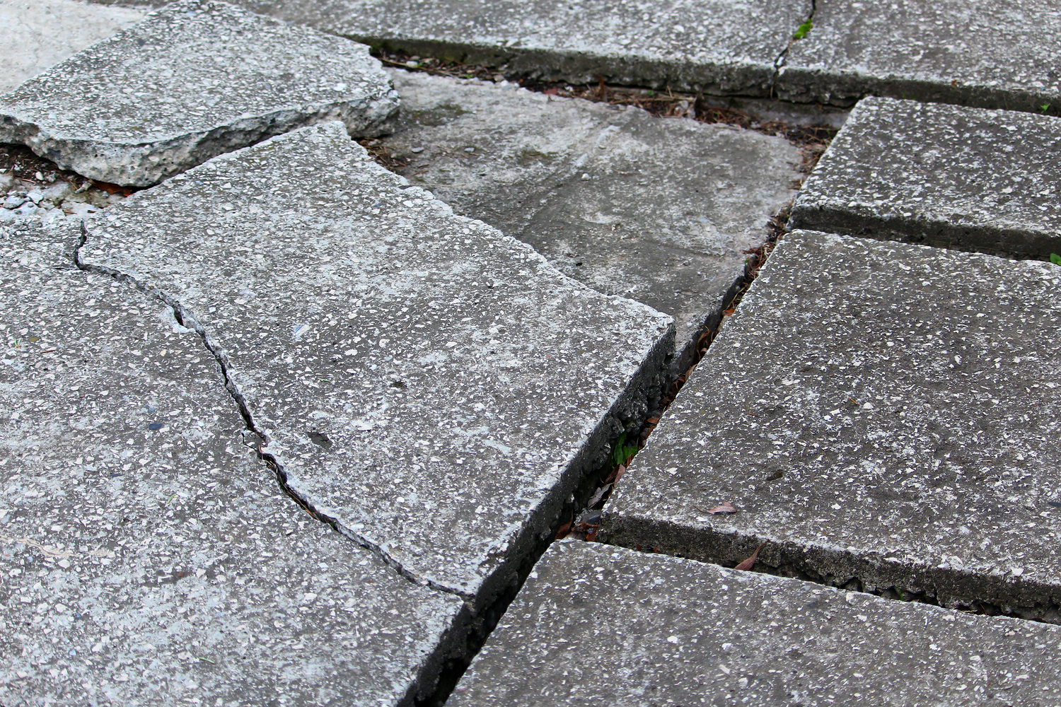 Cracked paving illustrating a potential fall hazard