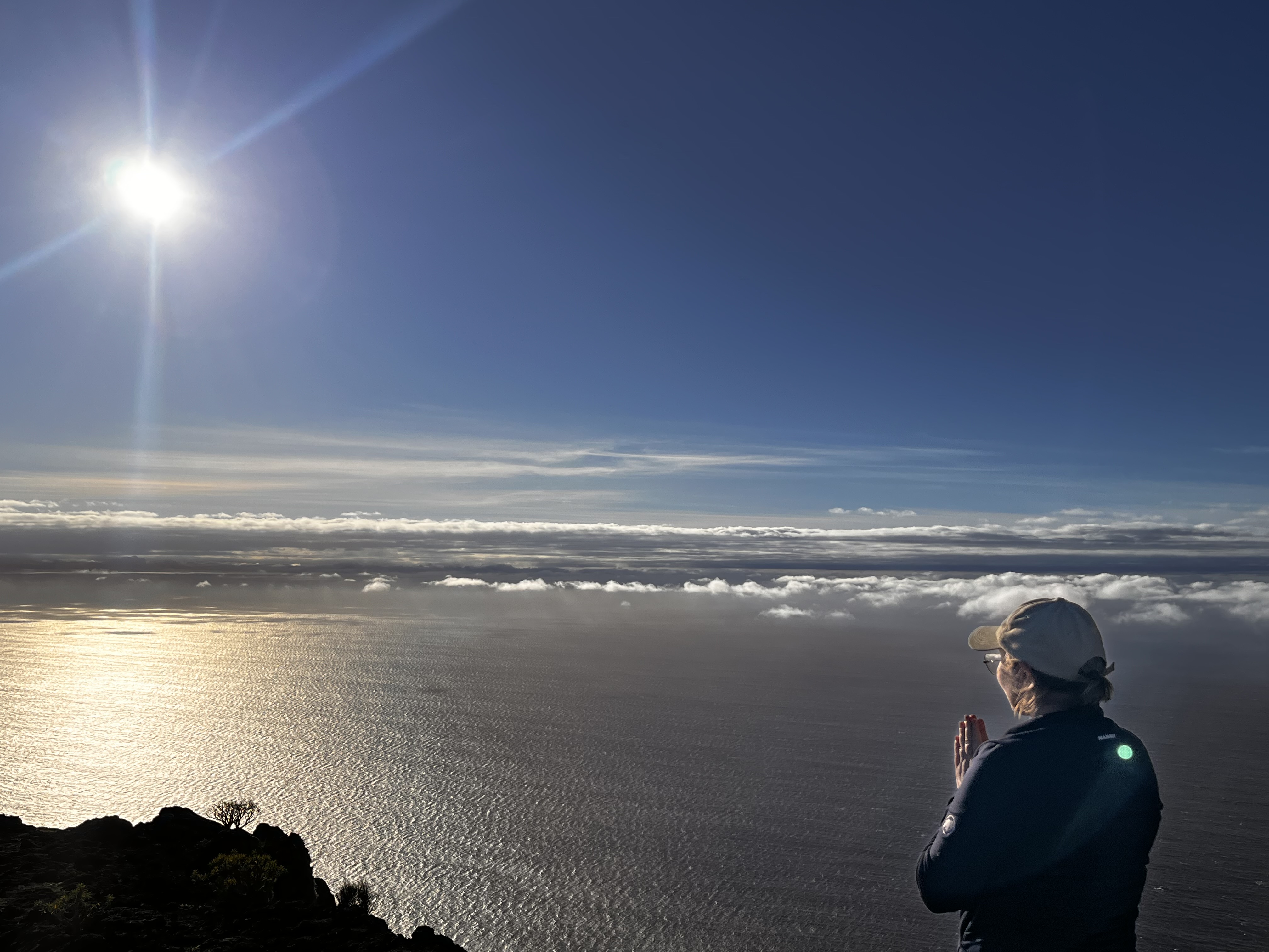 A woman in prayer overlooking the ocean in La Gomera
