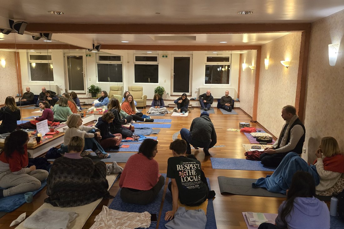 A circle gathered on the floor of the ashram
