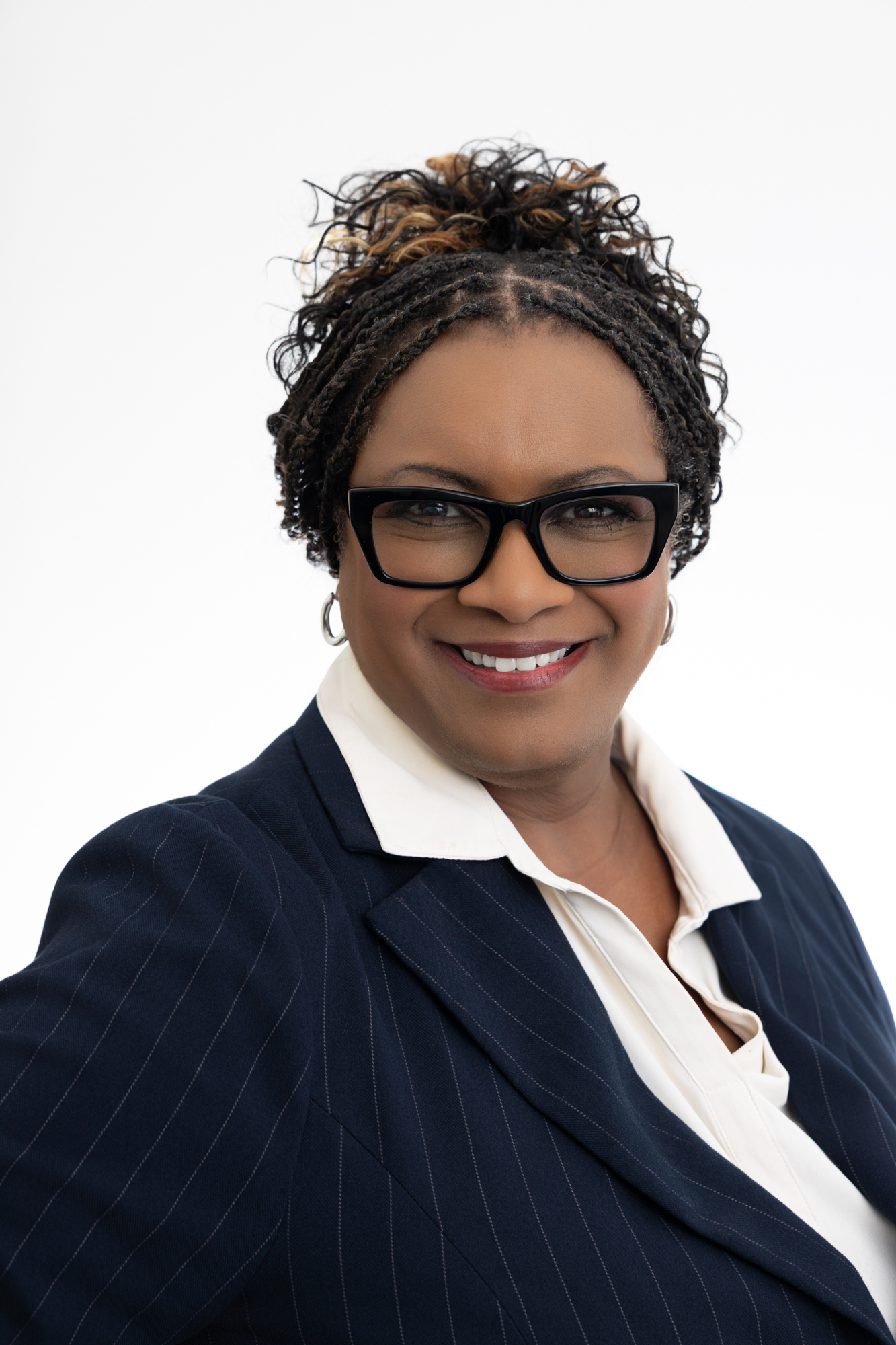Portrait of Dr. Trenna Richardson, Executive AI Strategist, in a navy pinstripe blazer