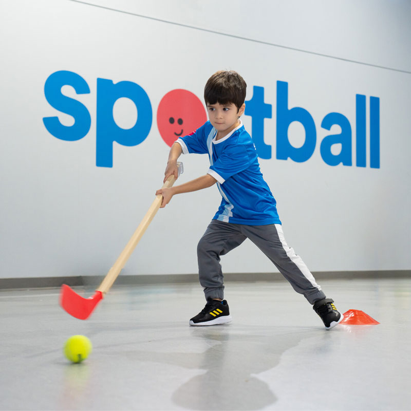 Toddler playing with ball indoors