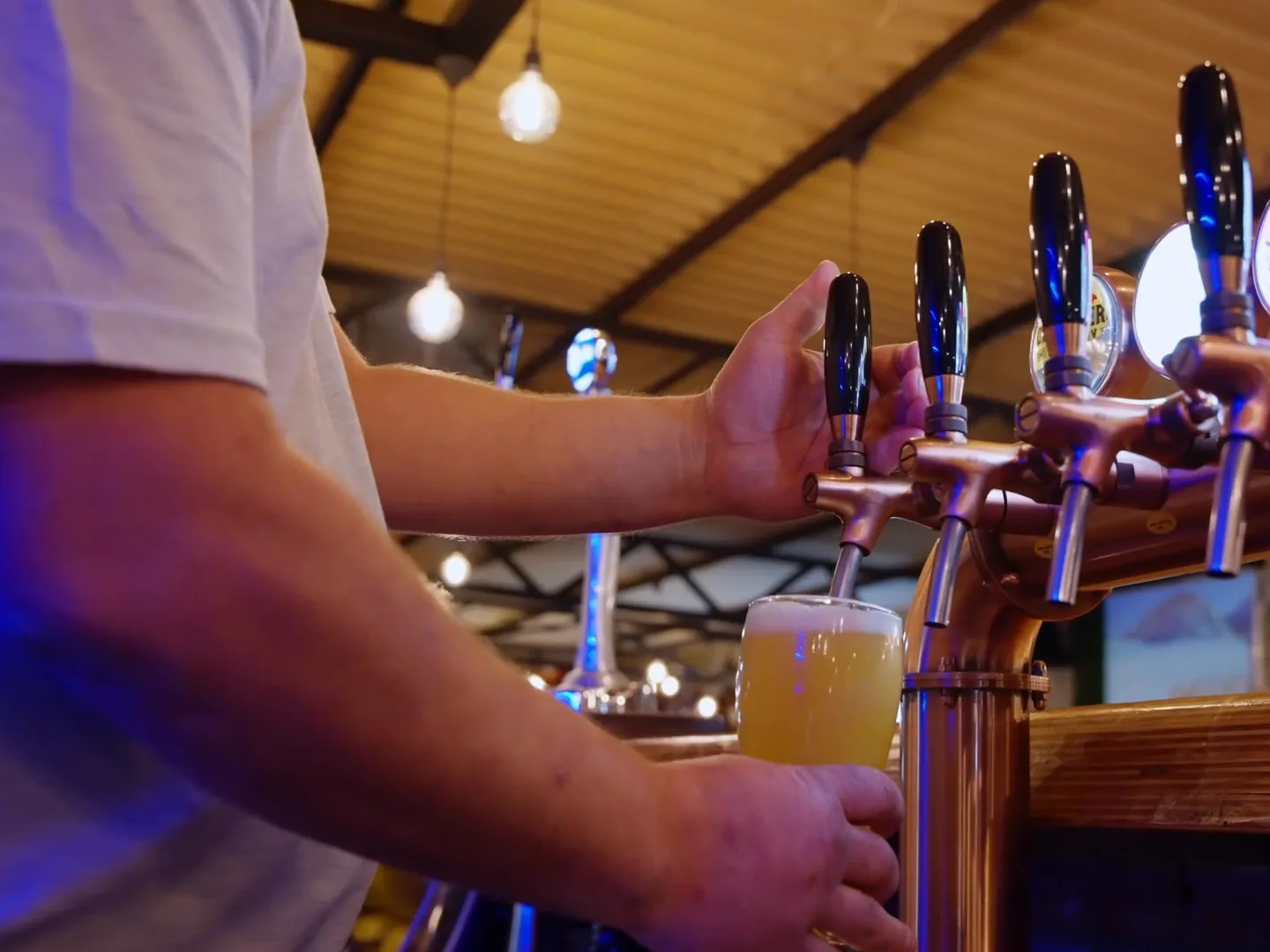 Bartender pouring a draught beer at Breezy's