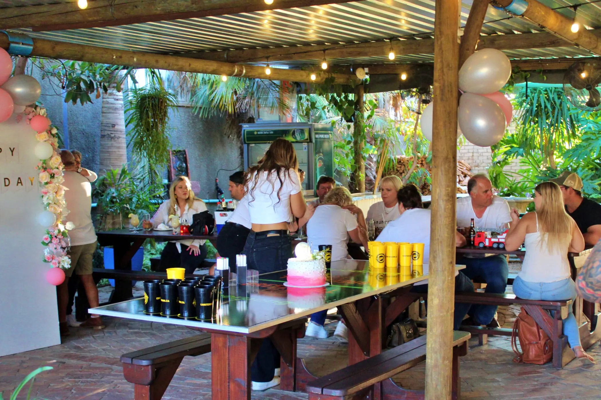 Outdoor celebration with balloons at Breezy's