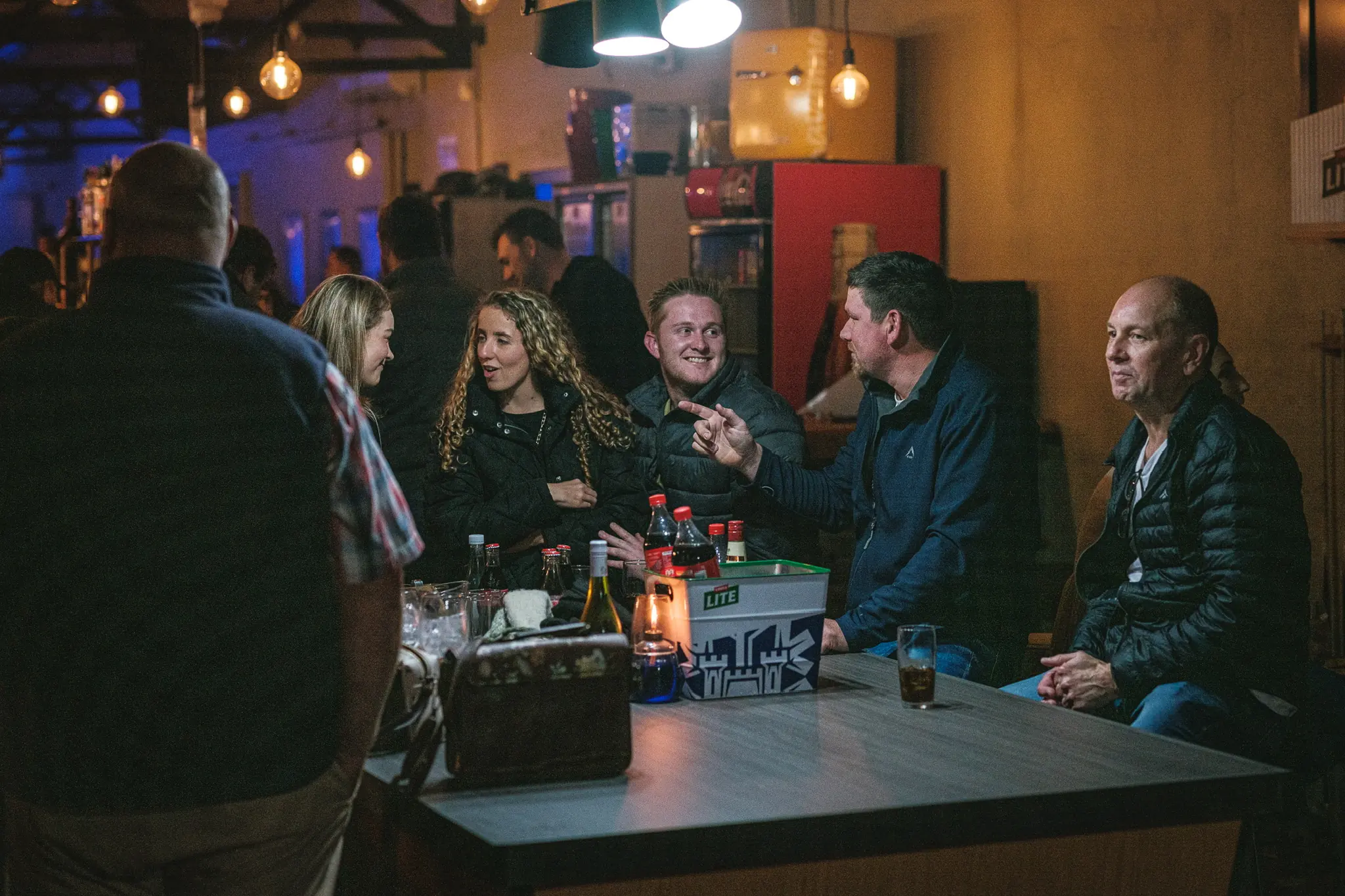 Group of friends at a table in a separate area at Breezy's