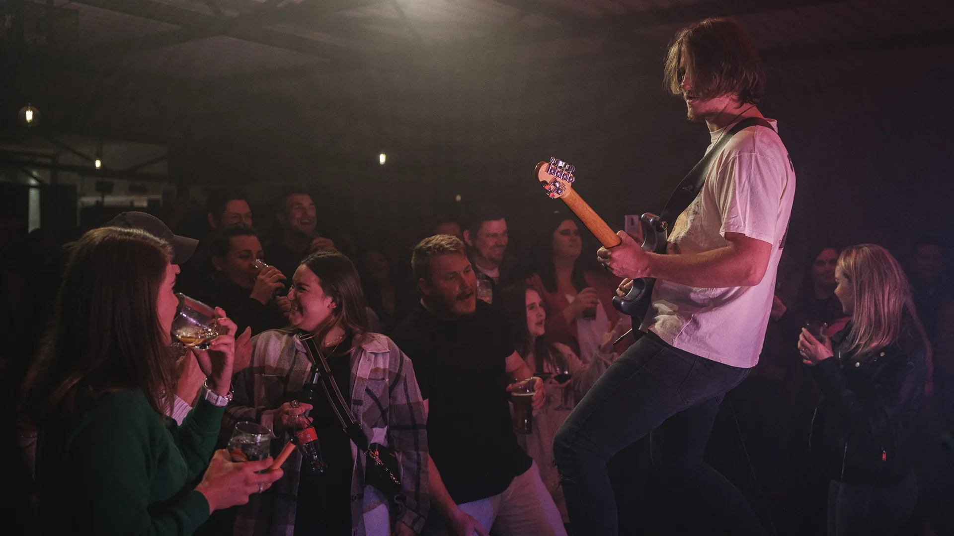 Guitarist performing live on stage to a crowd at Breezy's in Paarl