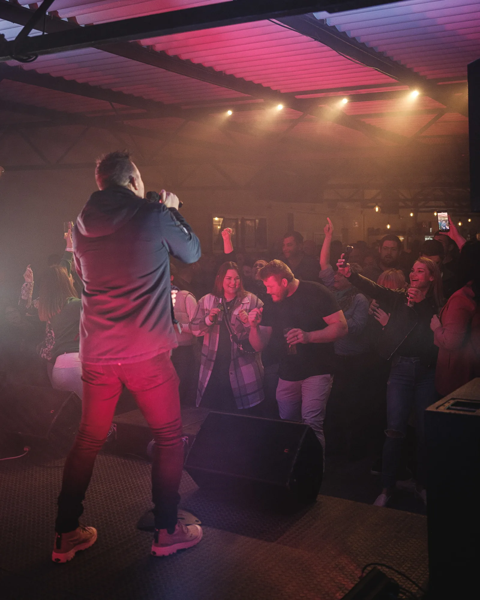 Crowd dancing in front of the stage while a singer performs at Breezy's