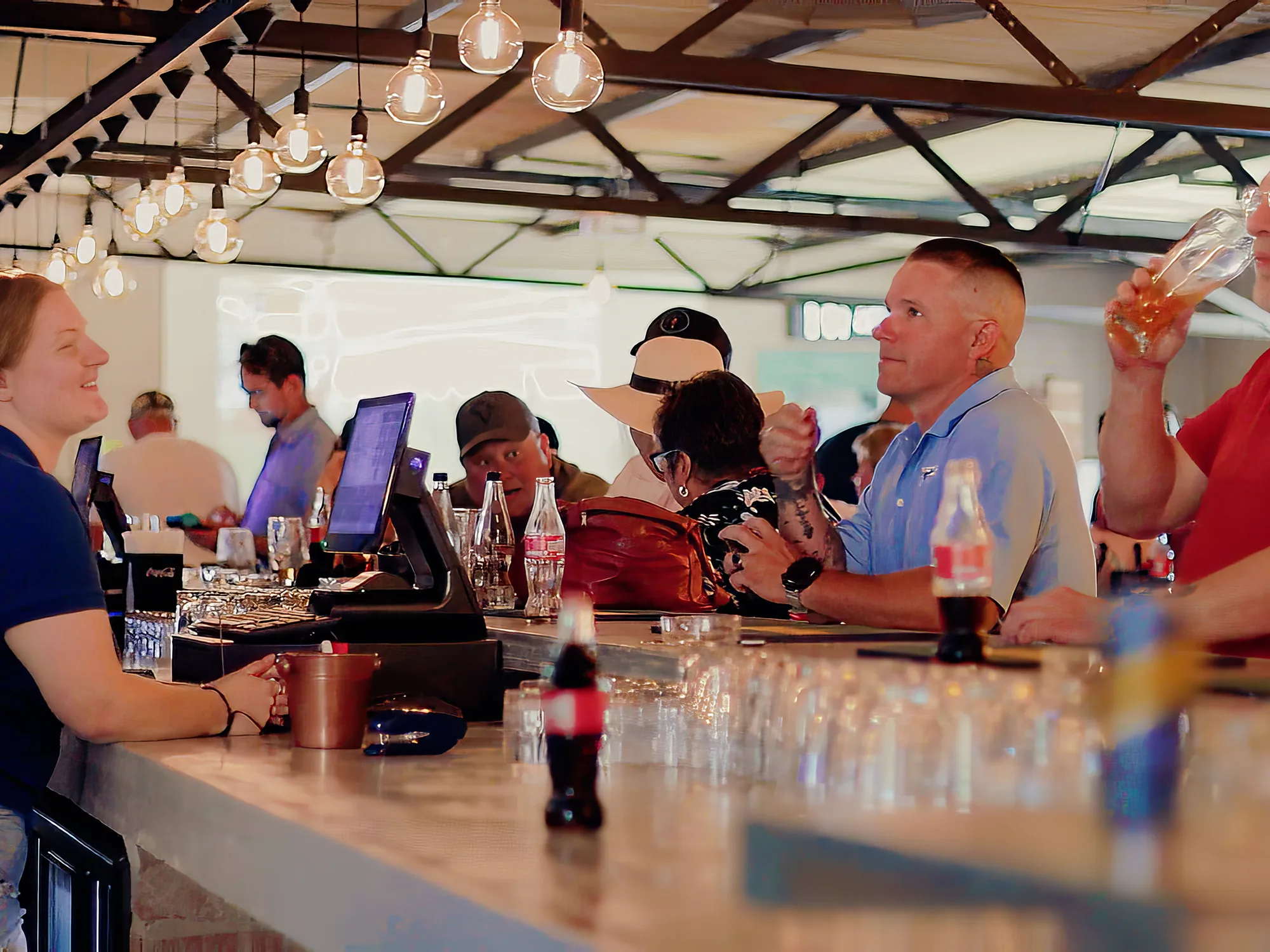 Guests at the bar being served at Breezy's