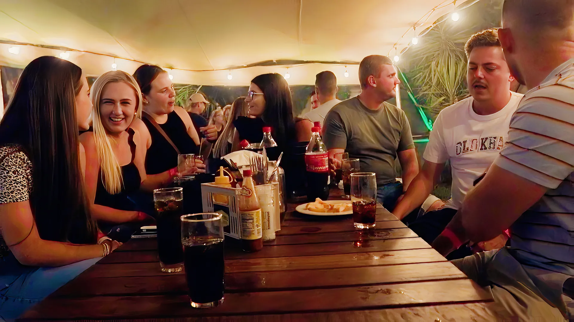 Friends at a table with drinks at Breezy's on a weeknight