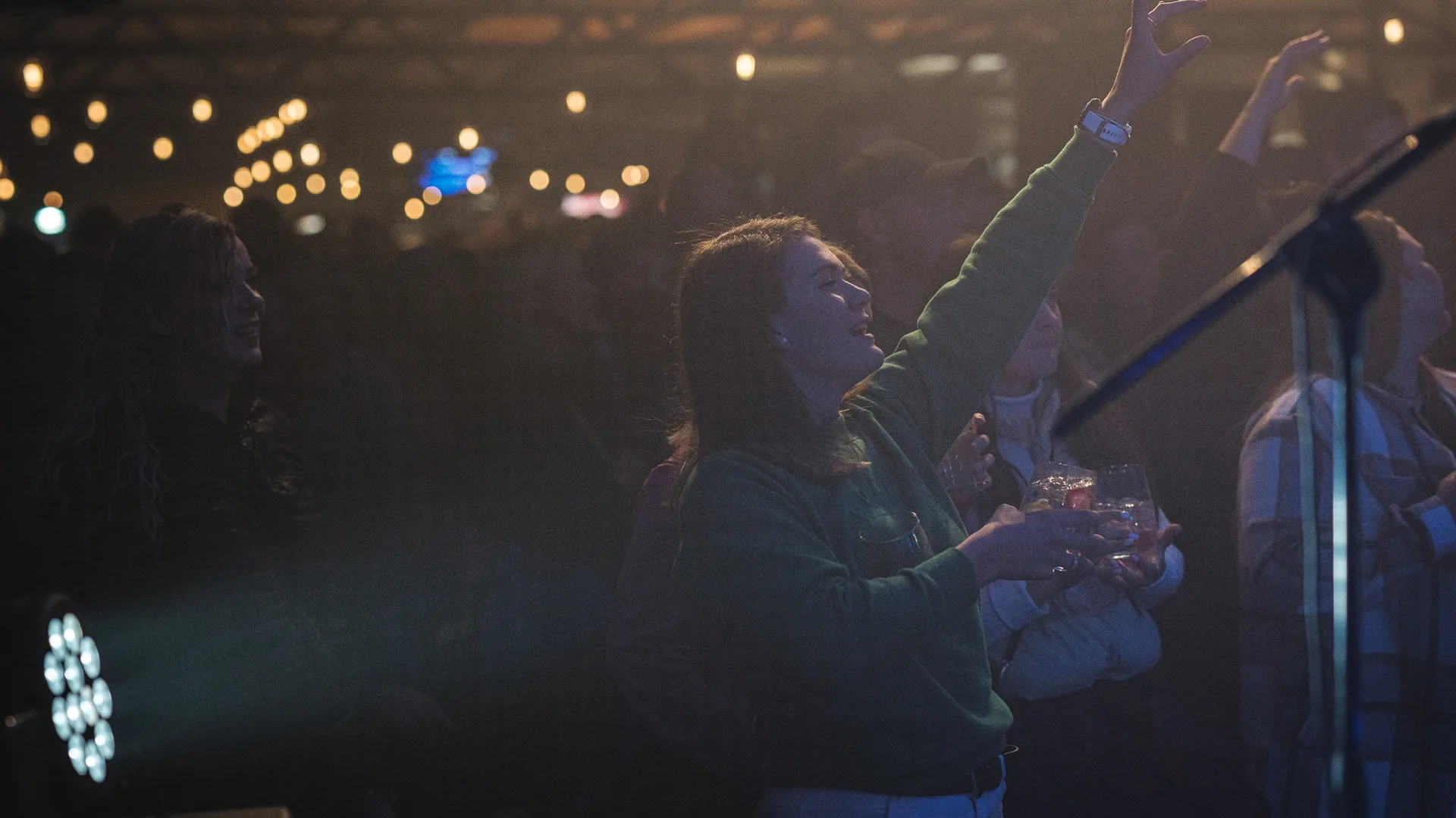 Singer on stage with the crowd and lights at a live show at Breezy's