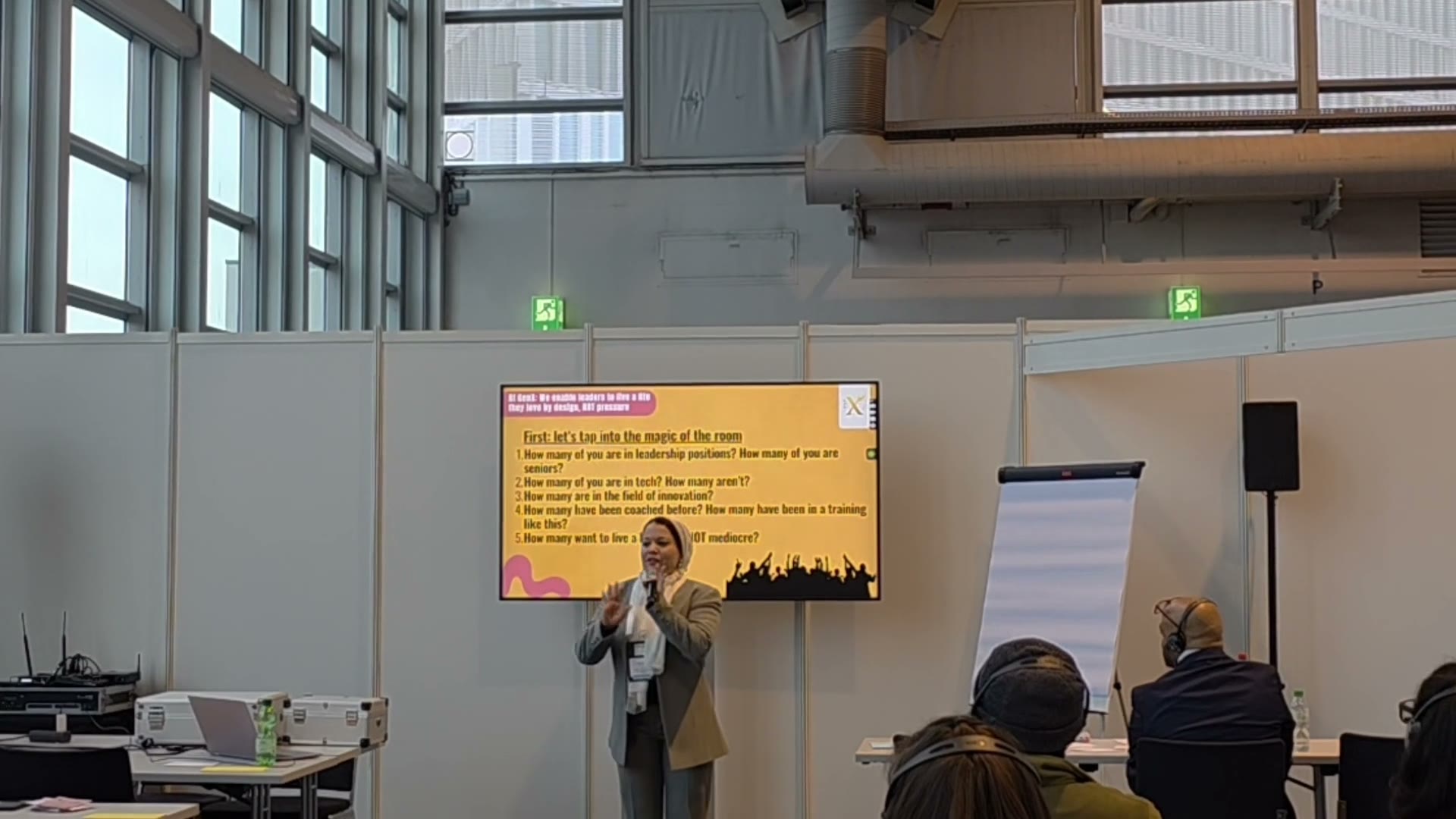 Sara leading a workshop in front of a presentation screen