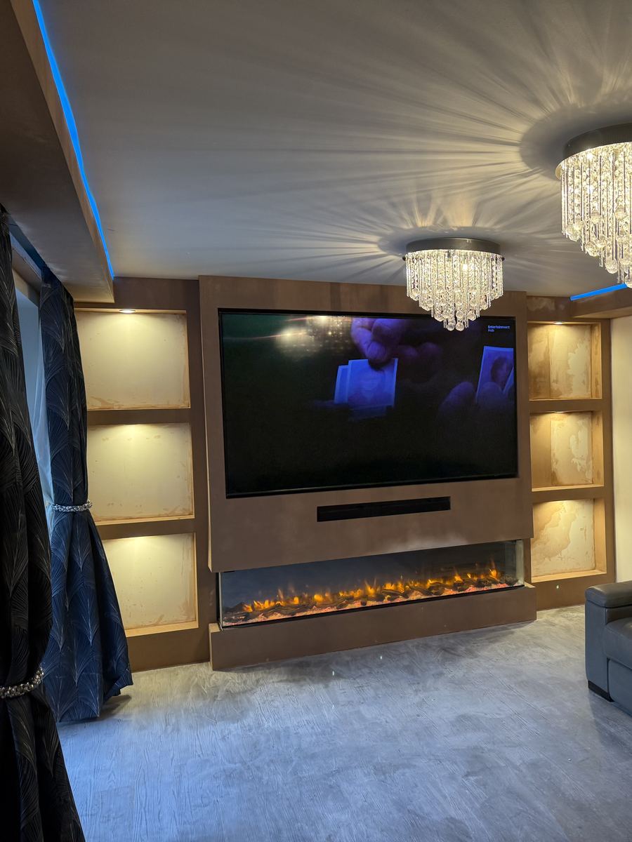 Media wall with lit alcoves, electric fire and an LED feature ceiling