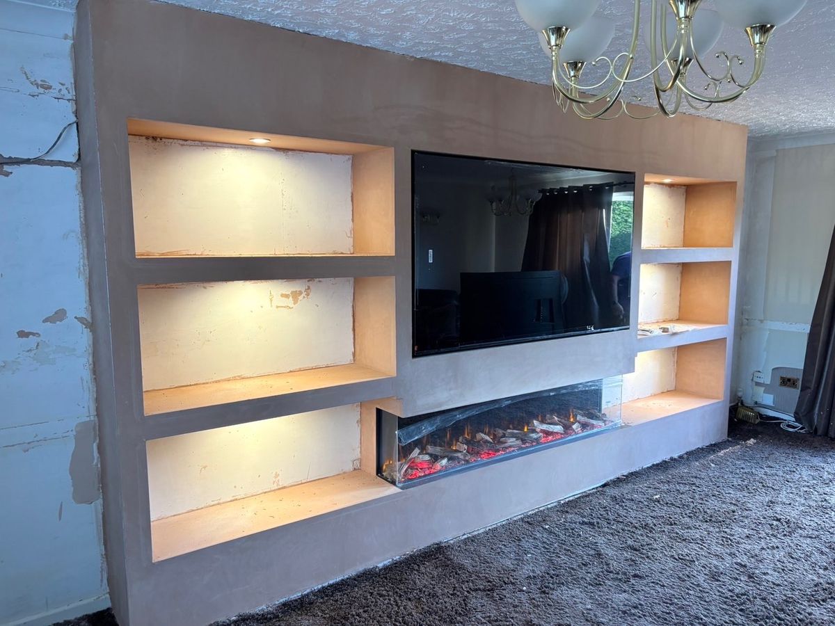 The finished media wall with three lit alcoves each side, TV and electric fire