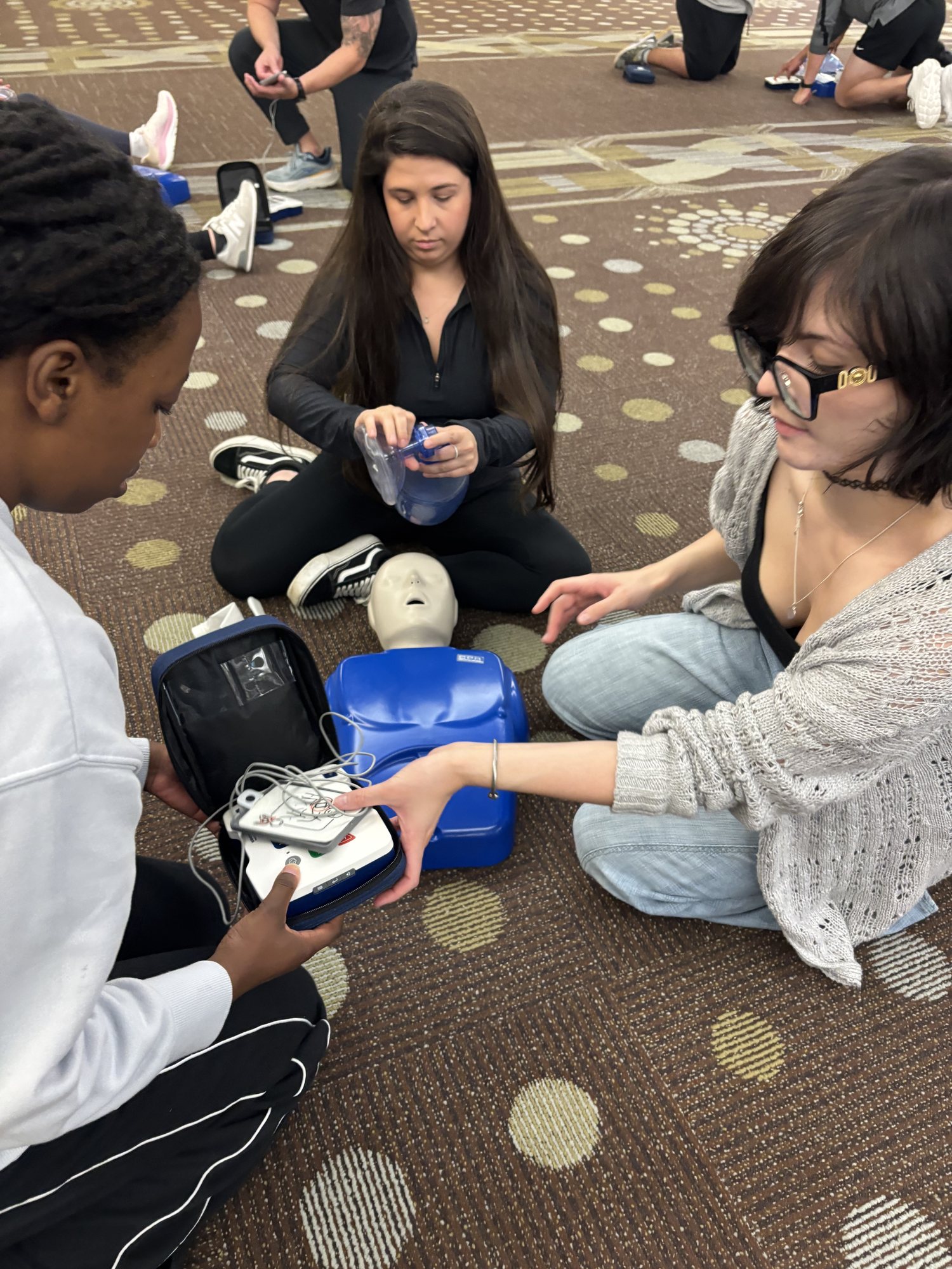 Hands-on AED practice during an onsite safety training session