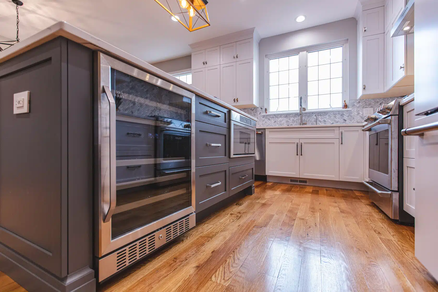 Modern open-concept kitchen and dining area by RemodelX