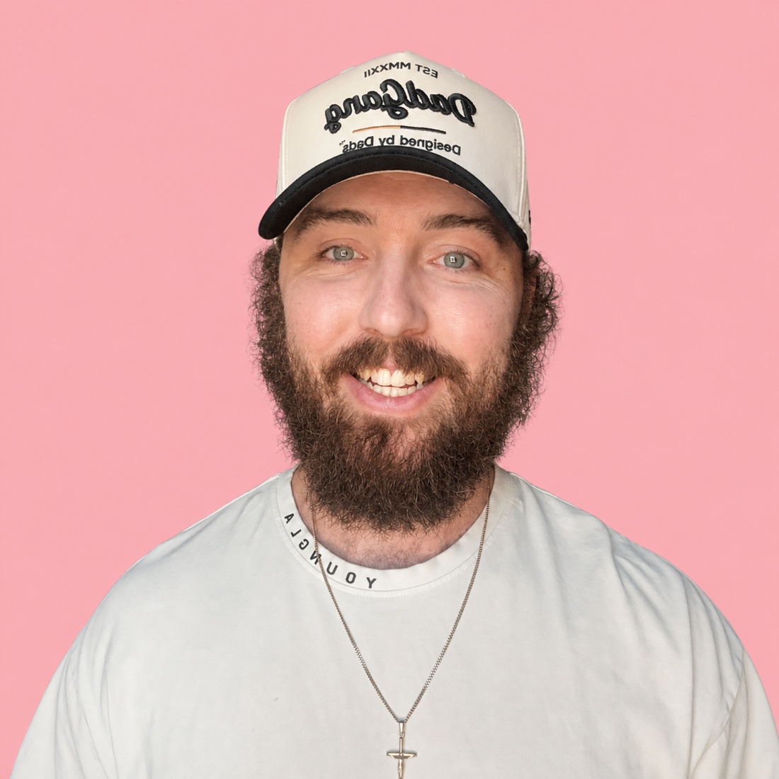 Jake Medford, founder of Stacked Strategies, smiling against a pink background