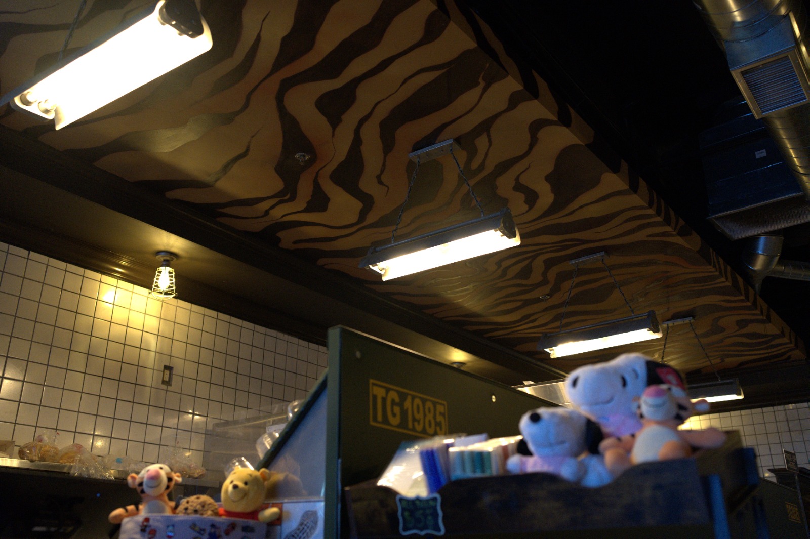 TG Cafe interior with tiger-pattern ceiling