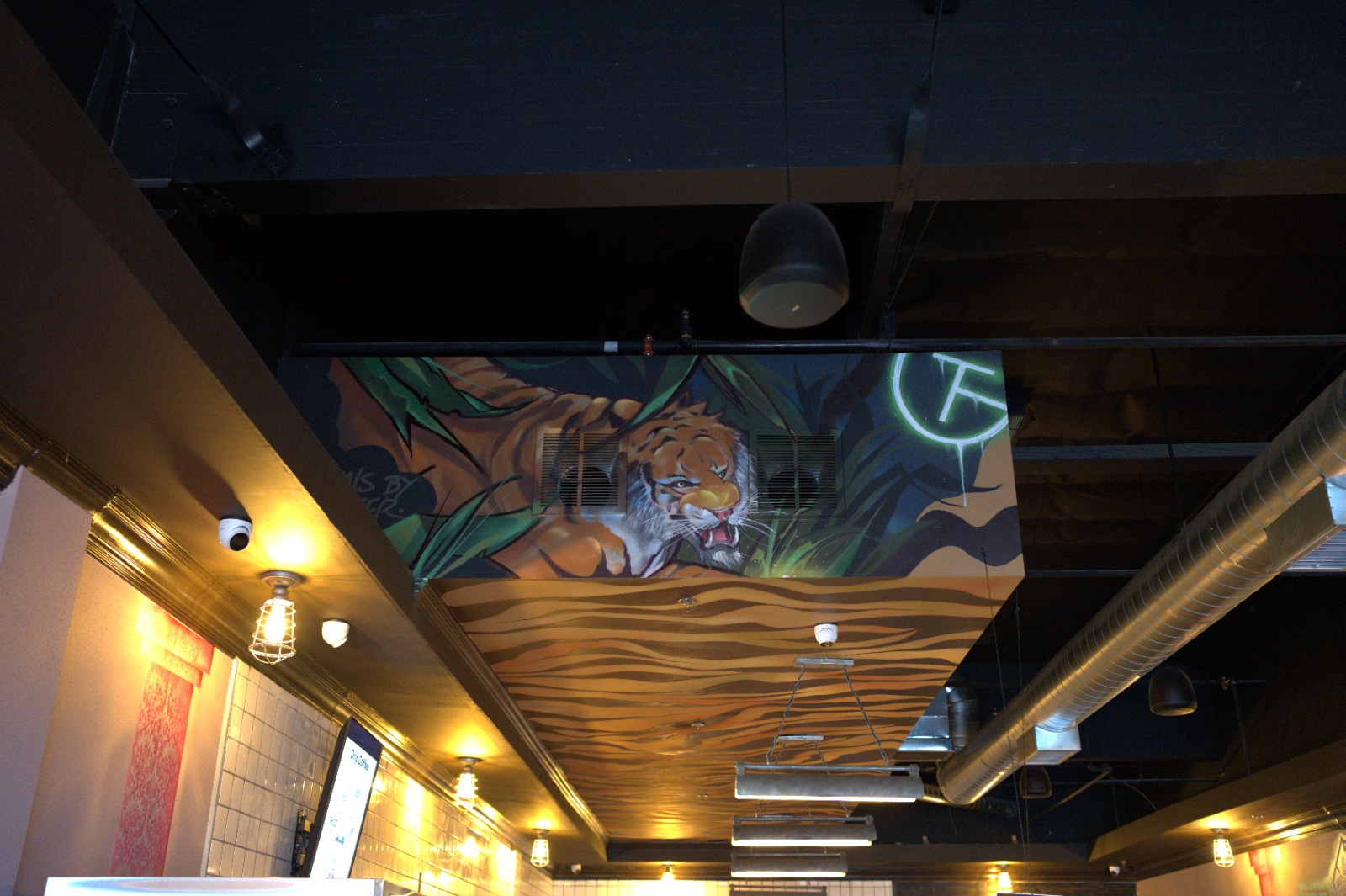 Tiger mural and lighting inside TG Cafe