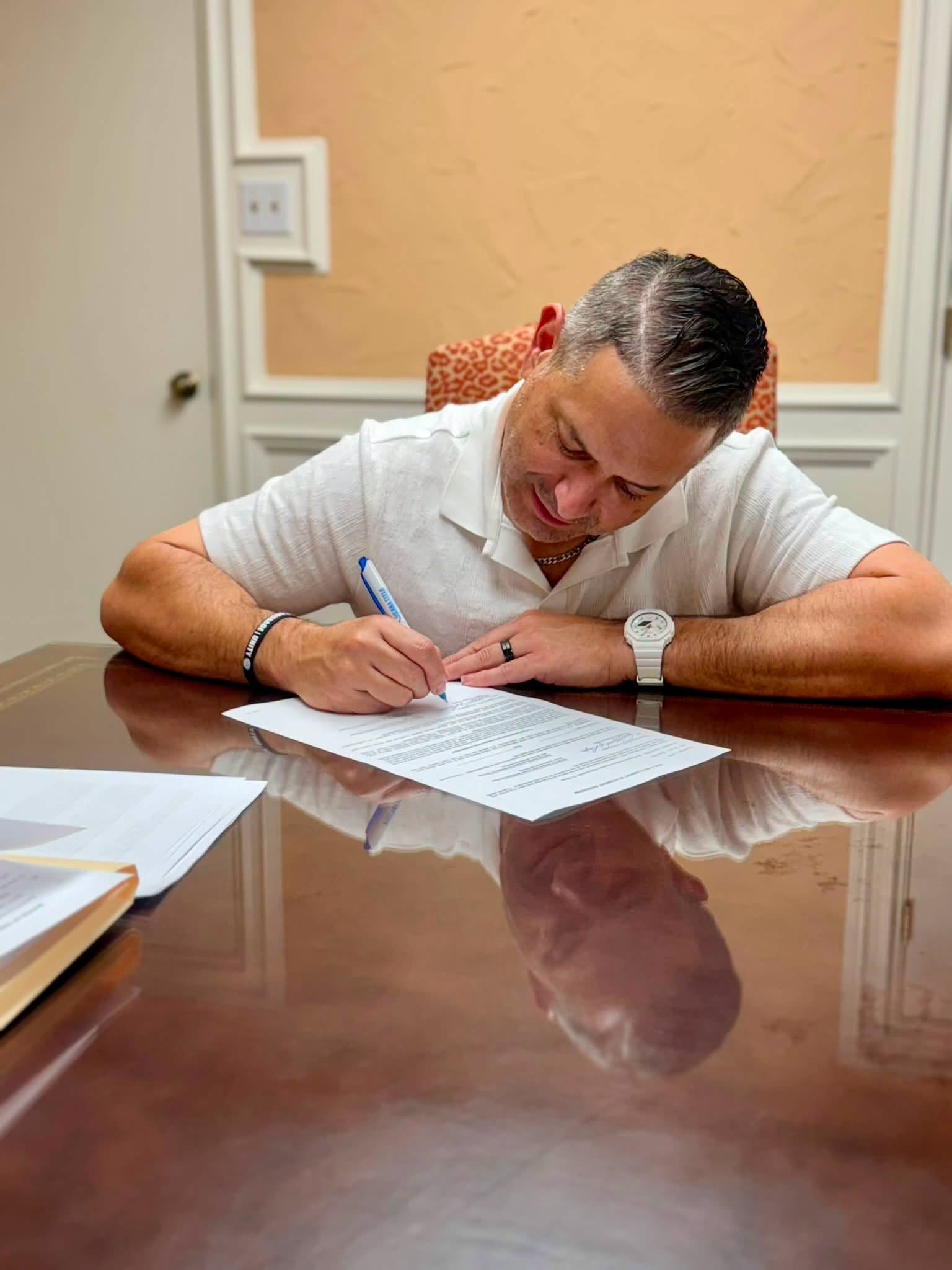 Signing a business document at a conference table