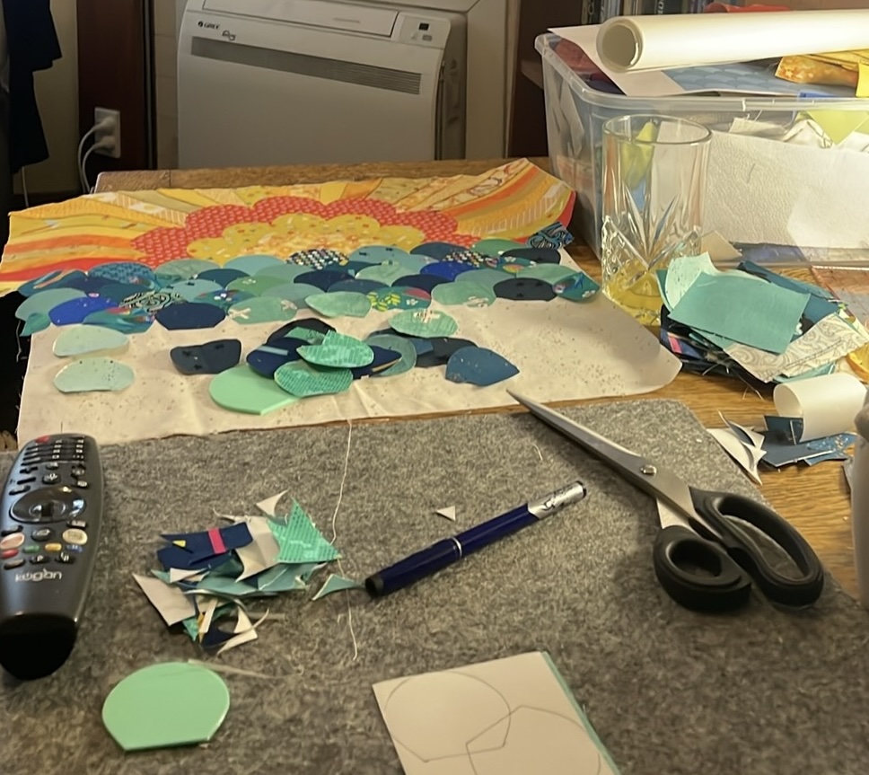 Wave and clamshell shapes prepared with Vliesofix and ready for appliqué on the summer mini quilt.
