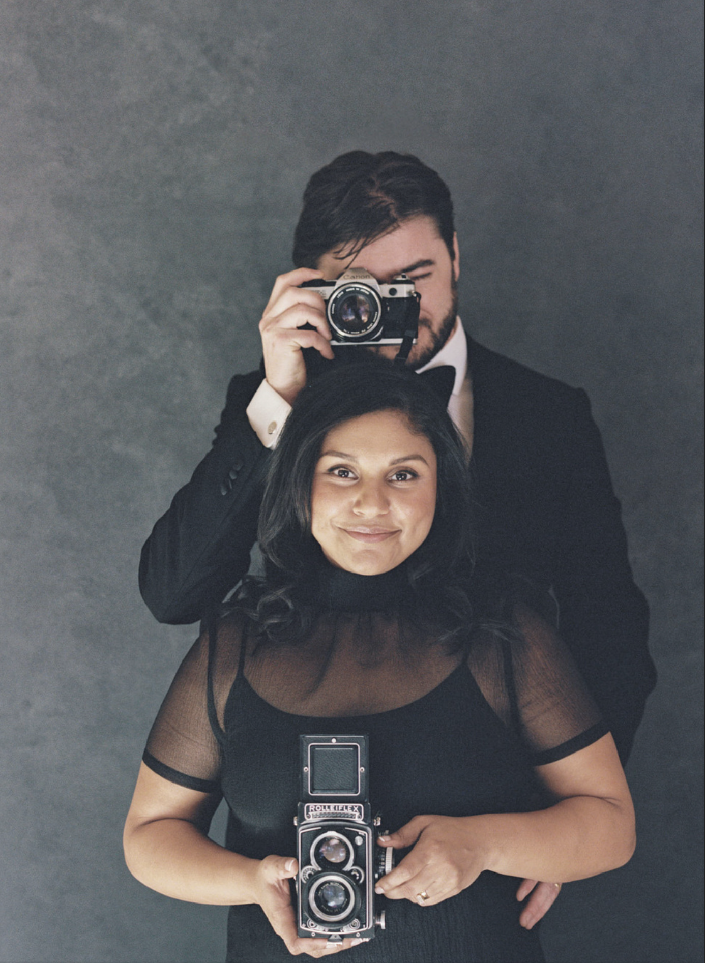Radhika and Ian of Radian Photography, each holding a camera