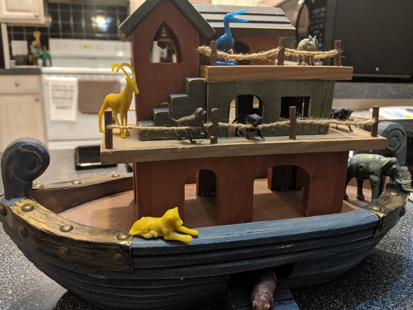 Handcrafted wooden Noah's Ark model with carved animal figurines