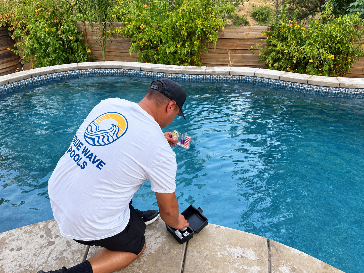 True Wave Pools crew cleaning a backyard pool in Temecula, CA