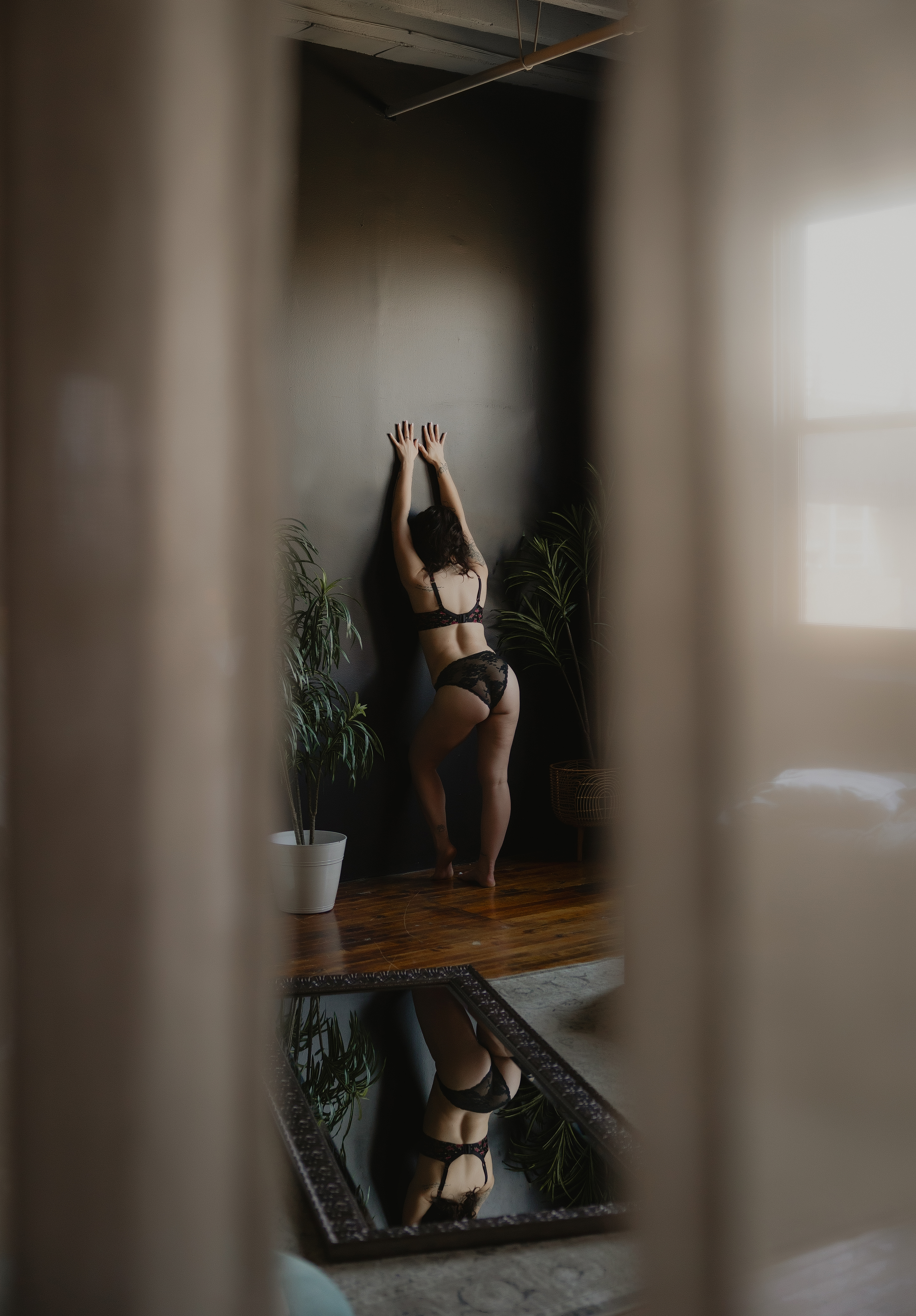 woman stretching arms up in lingerie, empowerment boudoir photography session