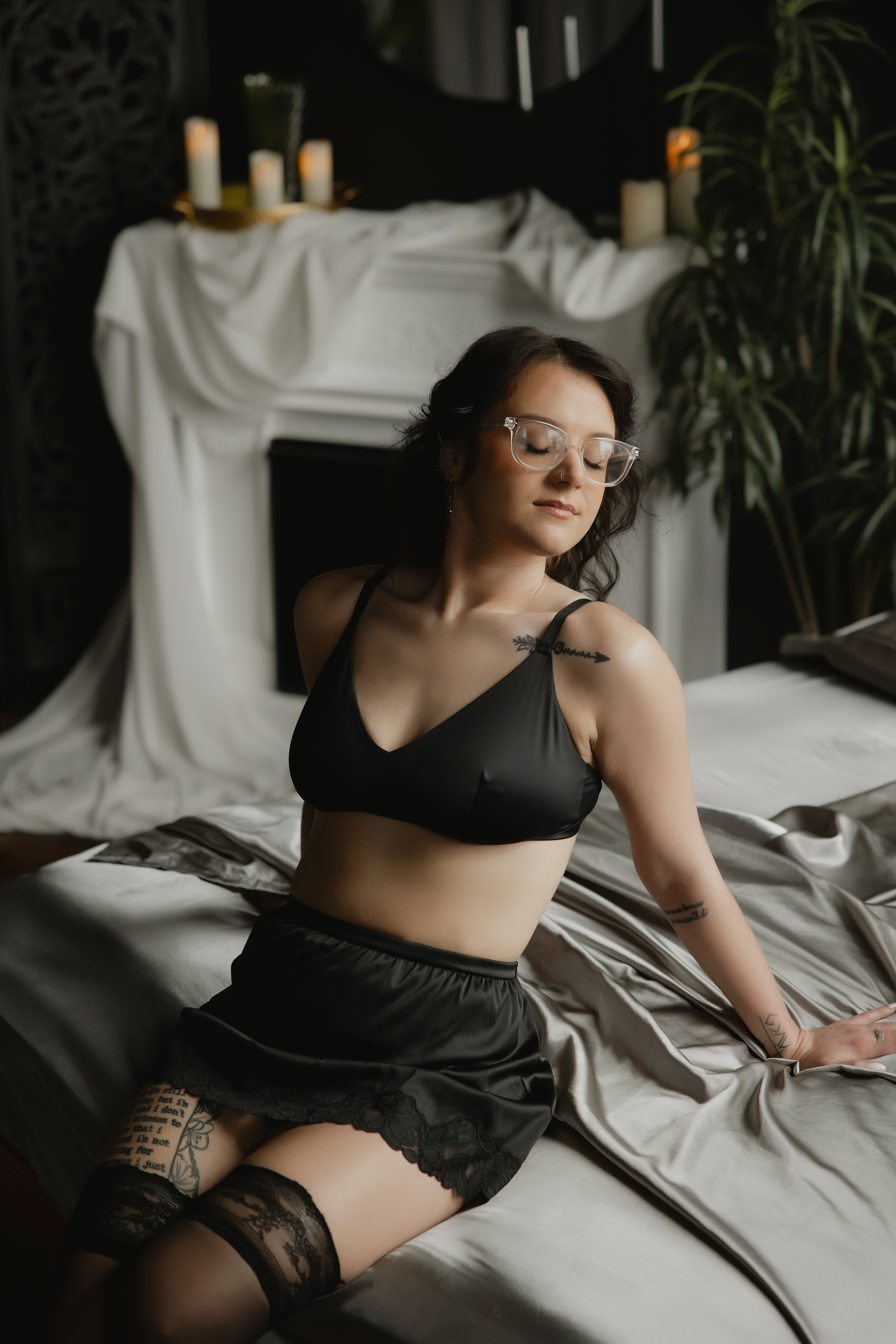 woman wearing glasses in black lingerie, intimate in-home boudoir photography