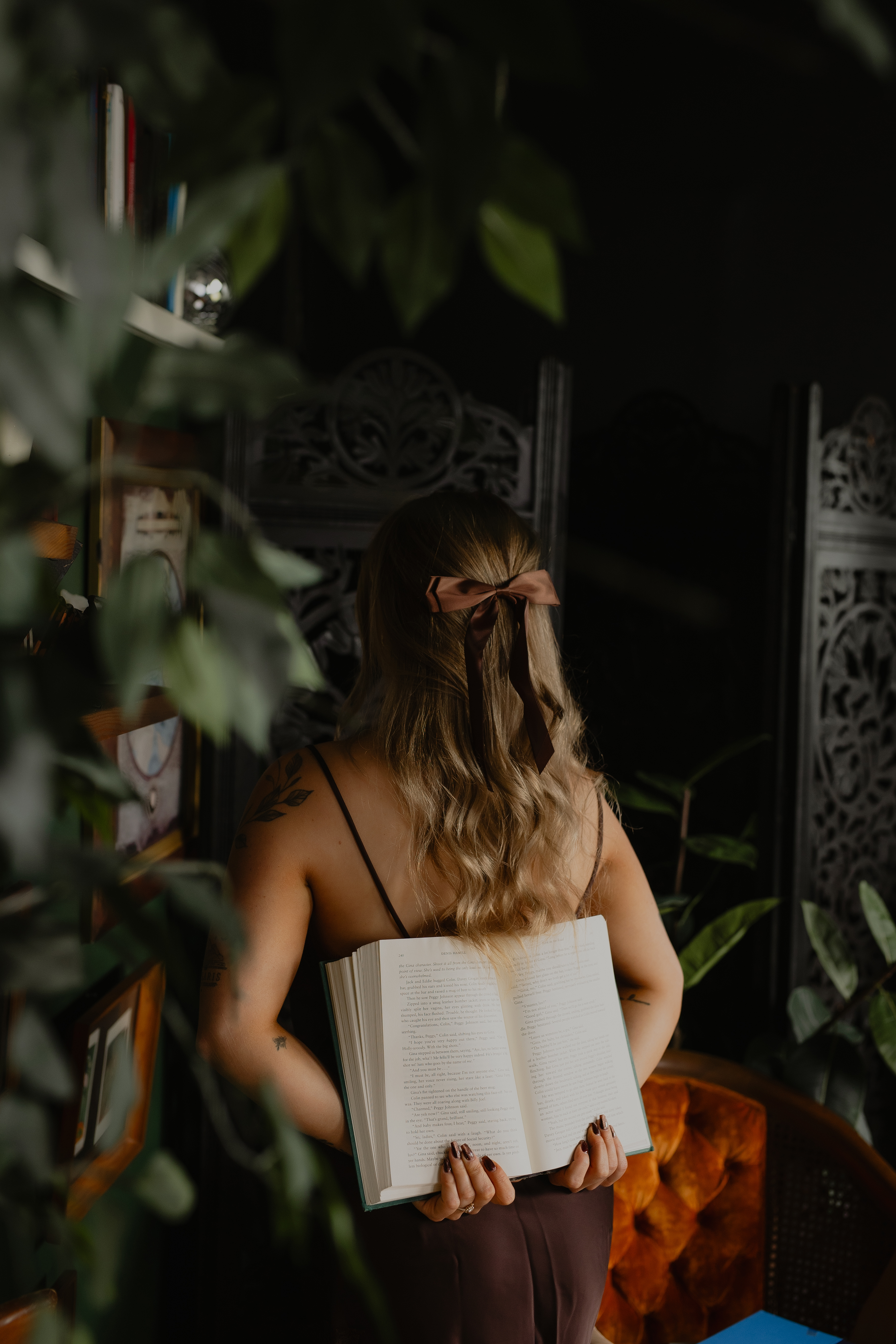 girl holding book behind her back