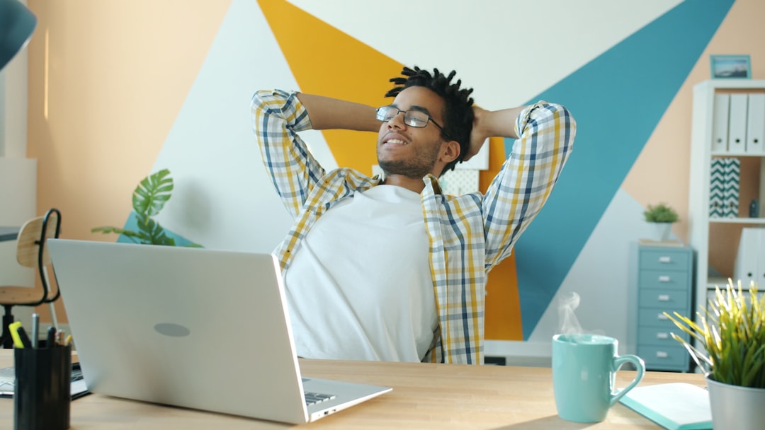 Business owner leaning back at his desk, calm and focused