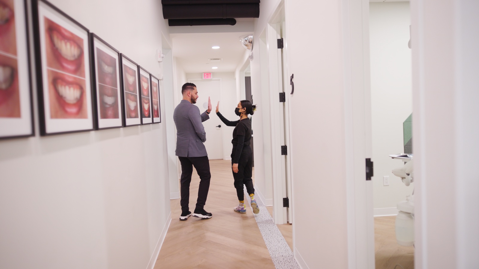 Limitless Dental team members high-fiving in the hallway